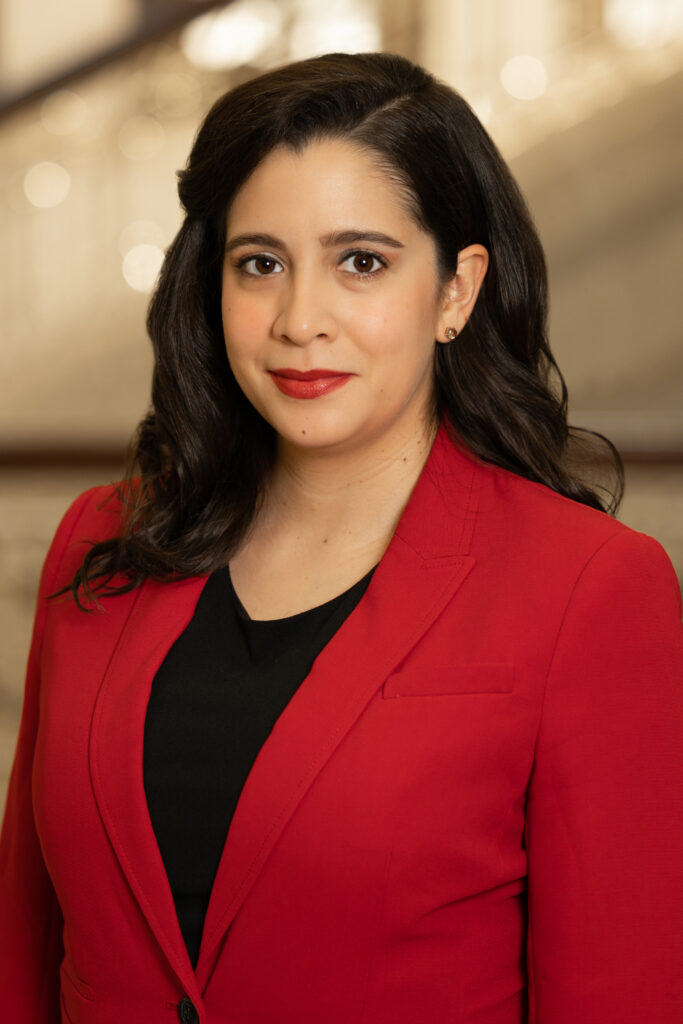 Portrait of a woman in a red jacket and light background